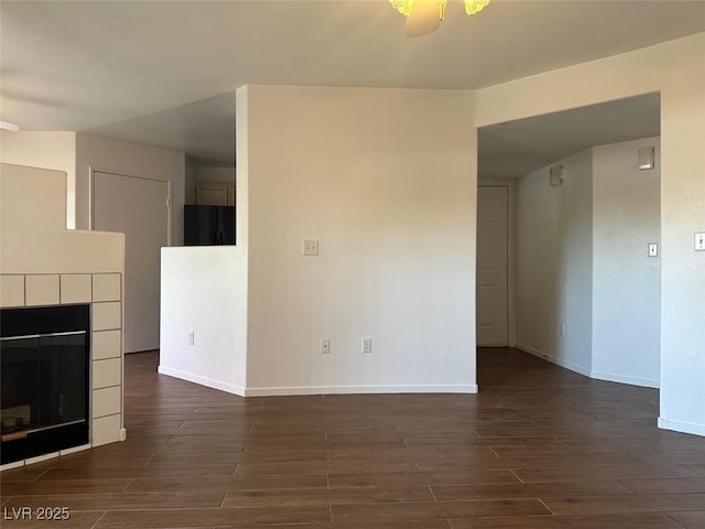 698 S Racetrack Rd Unit 1411, Henderson, NV 89015 - unfurnished living room featuring dark wood-type flooring and baseboards