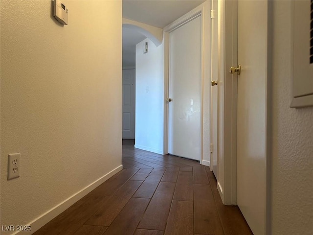 698 S Racetrack Rd Unit 1411, Henderson, NV 89015 - hallway with arched walkways, baseboards, dark wood-style floors, and a textured wall