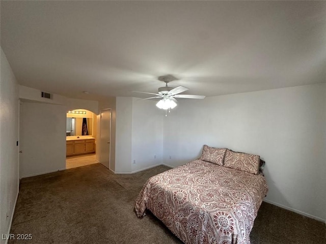698 S Racetrack Rd Unit 1411, Henderson, NV 89015 - bedroom with carpet, arched walkways, ceiling fan, and ensuite bathroom