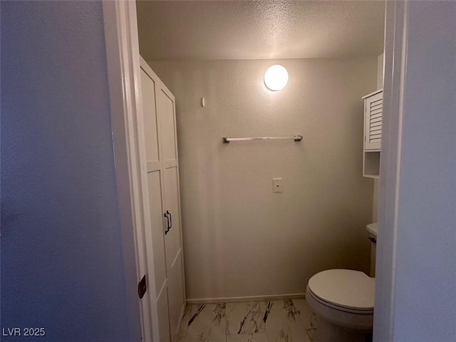 698 S Racetrack Rd Unit 1411, Henderson, NV 89015 - bathroom with marble finish floors, toilet, a textured ceiling, and baseboards