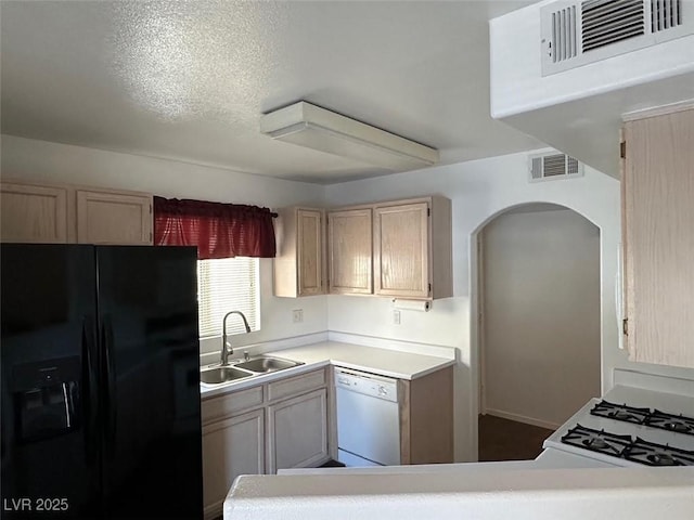698 S Racetrack Rd Unit 1411, Henderson, NV 89015 - kitchen featuring black fridge with ice dispenser, dishwasher, a sink, arched walkways, and light countertops