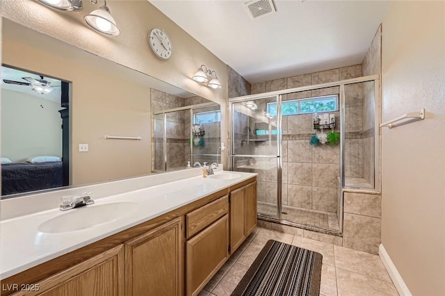 1116 Avellino Ln, Las Vegas, NV 89144 - bathroom featuring a shower stall, double vanity, connected bathroom, tile patterned floors, and a ceiling fan