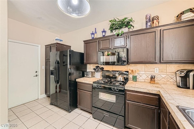 1116 Avellino Ln, Las Vegas, NV 89144 - kitchen with black appliances, dark brown cabinetry, backsplash, and light tile patterned floors