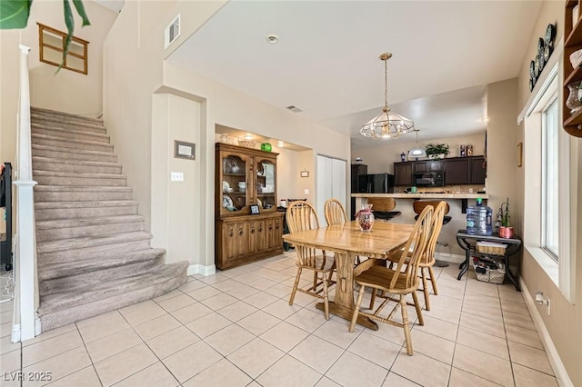 1116 Avellino Ln, Las Vegas, NV 89144 - dining space with stairway, light tile patterned floors, a chandelier, and baseboards