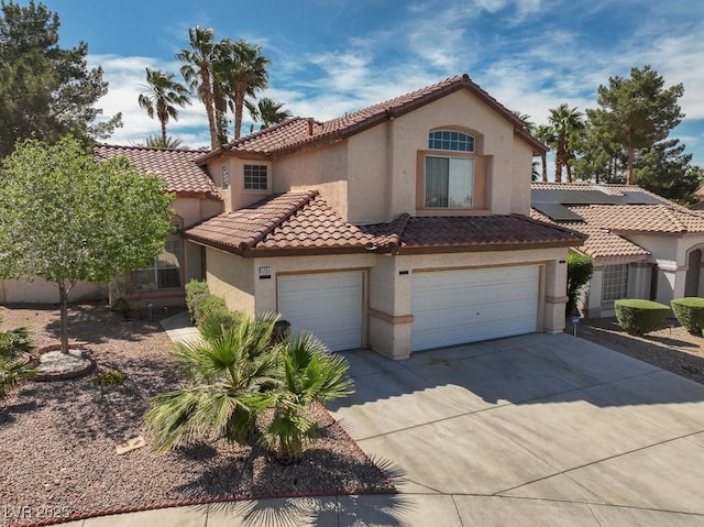 1721 Mill Canyon Dr, Las Vegas, NV 89128 - mediterranean / spanish-style home featuring stucco siding, a tiled roof, driveway, and a garage
