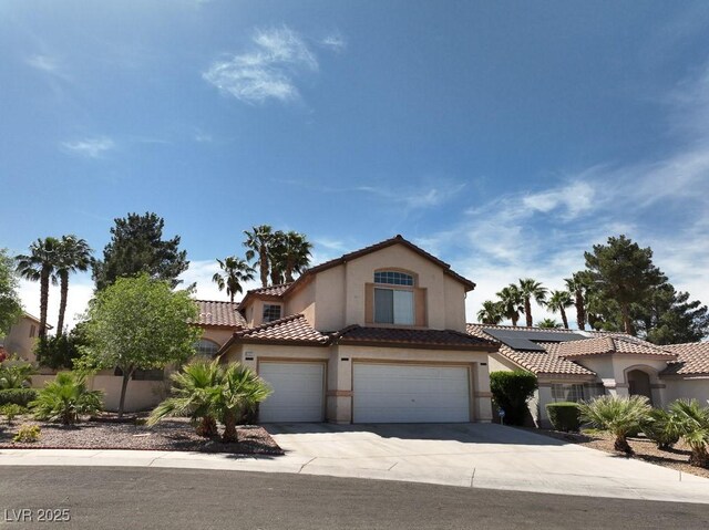1721 Mill Canyon Dr, Las Vegas, NV 89128 - view of front facade with concrete driveway, stucco siding, a tile roof, and a garage