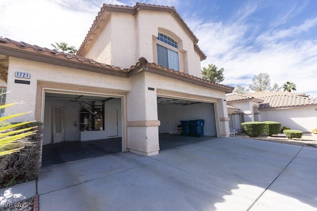 1721 Mill Canyon Dr, Las Vegas, NV 89128 - view of front of home with an attached garage, driveway, stucco siding, and a tile roof