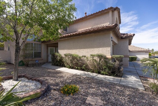 1721 Mill Canyon Dr, Las Vegas, NV 89128 - view of side of property featuring stucco siding and a tiled roof