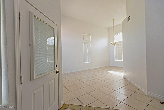 1721 Mill Canyon Dr, Las Vegas, NV 89128 - spare room with a chandelier, light tile patterned floors, and baseboards