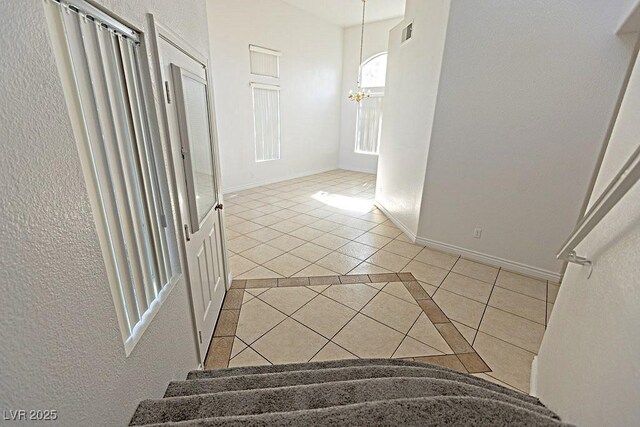 1721 Mill Canyon Dr, Las Vegas, NV 89128 - stairs with tile patterned floors, inlaid floor details, a chandelier, and baseboards