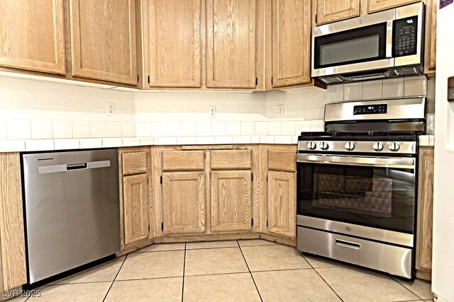 1721 Mill Canyon Dr, Las Vegas, NV 89128 - kitchen with appliances with stainless steel finishes, tile countertops, and light tile patterned flooring