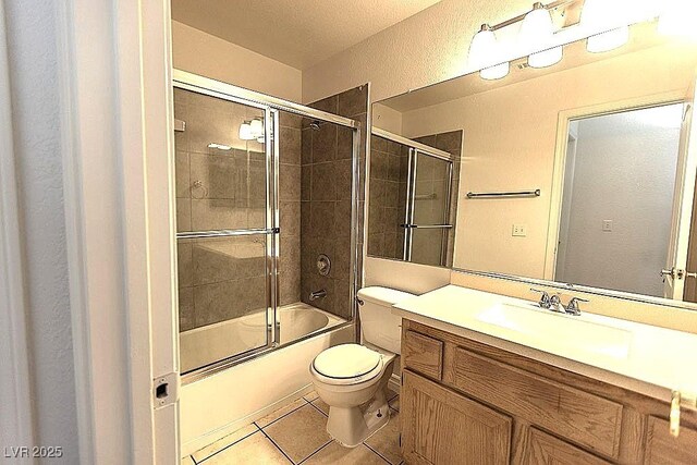 1721 Mill Canyon Dr, Las Vegas, NV 89128 - full bathroom featuring toilet, vanity, tile patterned flooring, combined bath / shower with glass door, and a textured wall