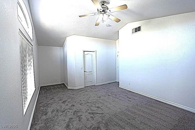 1721 Mill Canyon Dr, Las Vegas, NV 89128 - empty room with vaulted ceiling, carpet, baseboards, ceiling fan, and a textured ceiling