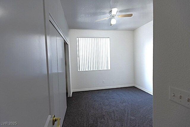 1721 Mill Canyon Dr, Las Vegas, NV 89128 - unfurnished bedroom with dark carpet, a closet, baseboards, a ceiling fan, and a textured ceiling