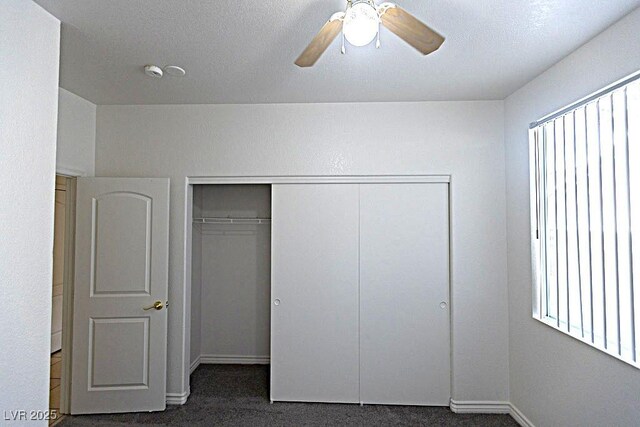 1721 Mill Canyon Dr, Las Vegas, NV 89128 - unfurnished bedroom featuring dark colored carpet, a closet, baseboards, and ceiling fan
