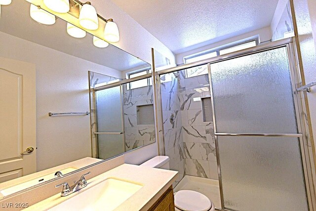1721 Mill Canyon Dr, Las Vegas, NV 89128 - full bathroom featuring vanity, a shower stall, toilet, and a textured ceiling