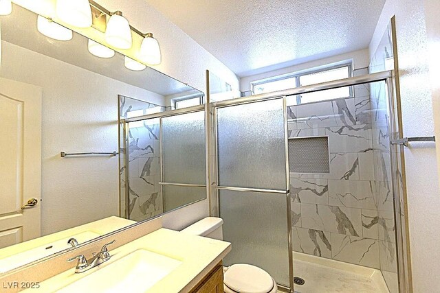 1721 Mill Canyon Dr, Las Vegas, NV 89128 - full bath featuring vanity, a stall shower, toilet, and a textured ceiling