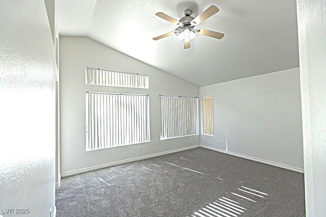 1721 Mill Canyon Dr, Las Vegas, NV 89128 - spare room with vaulted ceiling, a ceiling fan, carpet floors, and baseboards