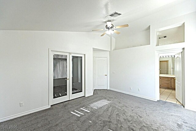 1721 Mill Canyon Dr, Las Vegas, NV 89128 - unfurnished bedroom with carpet floors, vaulted ceiling, baseboards, ceiling fan, and connected bathroom