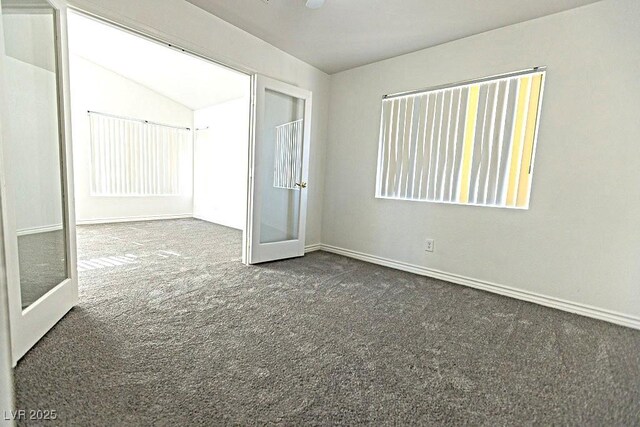 1721 Mill Canyon Dr, Las Vegas, NV 89128 - carpeted empty room featuring baseboards and lofted ceiling