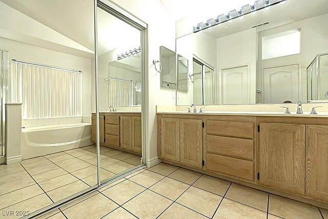 1721 Mill Canyon Dr, Las Vegas, NV 89128 - bathroom featuring a bath, tile patterned flooring, double vanity, a shower stall, and lofted ceiling