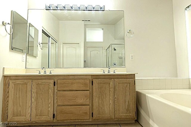 1721 Mill Canyon Dr, Las Vegas, NV 89128 - full bathroom featuring a garden tub, double vanity, a stall shower, and tile patterned flooring