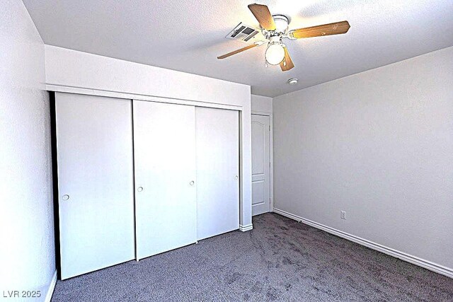 1721 Mill Canyon Dr, Las Vegas, NV 89128 - unfurnished bedroom featuring carpet, a closet, a ceiling fan, and baseboards