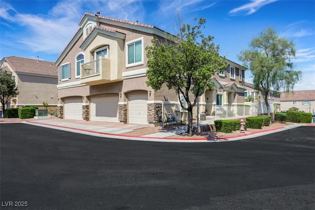1101 Elation Ln Unit 2, Henderson, NV 89002 - view of property featuring stucco siding, stone siding, a garage, a residential view, and driveway