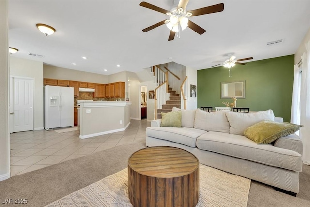 1101 Elation Ln Unit 2, Henderson, NV 89002 - living room with light tile patterned floors, stairway, a ceiling fan, light colored carpet, and baseboards