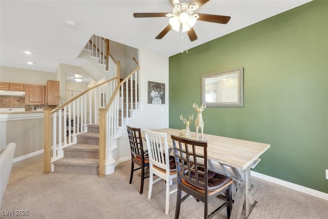 1101 Elation Ln Unit 2, Henderson, NV 89002 - dining space featuring ceiling fan, light colored carpet, stairs, and baseboards
