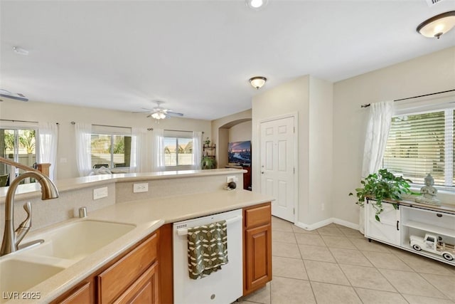 1101 Elation Ln Unit 2, Henderson, NV 89002 - kitchen with dishwasher, a sink, light tile patterned flooring, a ceiling fan, and brown cabinets