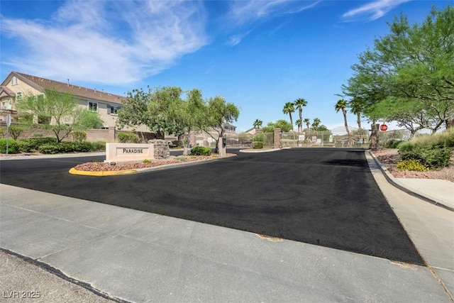 1101 Elation Ln Unit 2, Henderson, NV 89002 - view of asphalt road featuring curbs, a residential view, a gated entry, and traffic signs
