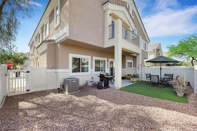 1101 Elation Ln Unit 2, Henderson, NV 89002 - back of house featuring central AC unit, stucco siding, a fenced backyard, and a patio