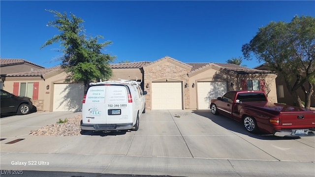 864 Chianti Way, Mesquite, NV 89027 - view of front of house featuring driveway, a garage, stone siding, stucco siding, and a tiled roof