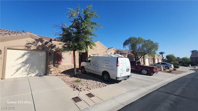 864 Chianti Way, Mesquite, NV 89027 - view of front of home featuring a garage, concrete driveway, and stone siding