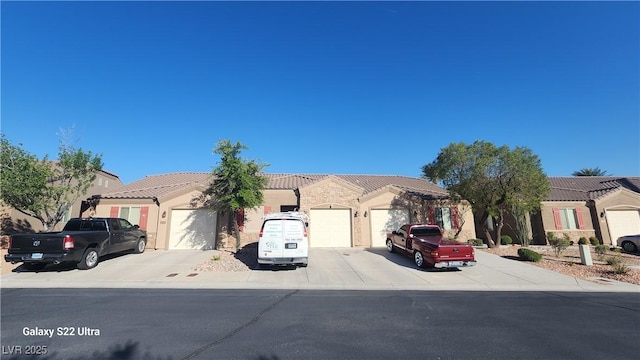 864 Chianti Way, Mesquite, NV 89027 - ranch-style home with an attached garage, concrete driveway, a tile roof, and stucco siding