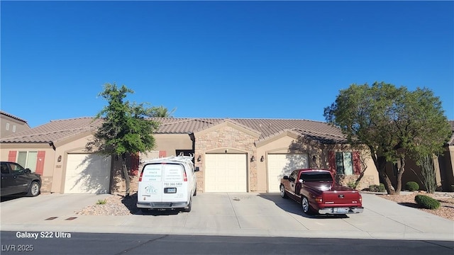864 Chianti Way, Mesquite, NV 89027 - single story home with a garage, concrete driveway, a tile roof, stone siding, and stucco siding