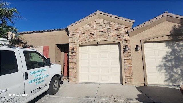 864 Chianti Way, Mesquite, NV 89027 - view of front of house featuring a tiled roof, stucco siding, stone siding, and driveway