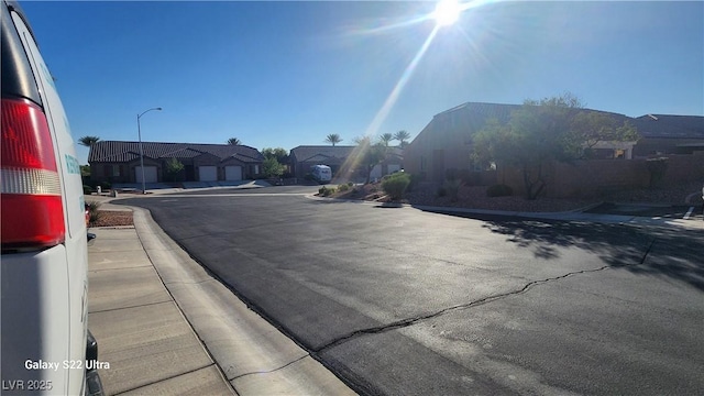 864 Chianti Way, Mesquite, NV 89027 - view of asphalt road with street lighting, a residential view, sidewalks, and curbs