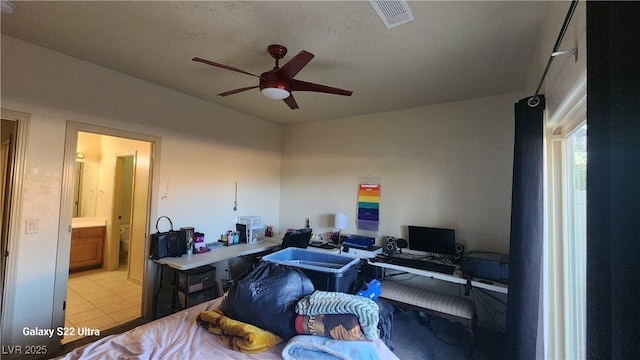 864 Chianti Way, Mesquite, NV 89027 - bedroom with an office area, connected bathroom, and light tile patterned floors