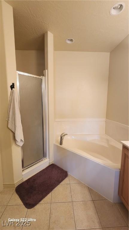 864 Chianti Way, Mesquite, NV 89027 - full bath featuring tile patterned flooring, a shower stall, a bath, vanity, and recessed lighting