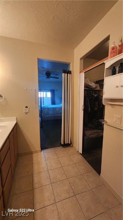 864 Chianti Way, Mesquite, NV 89027 - bathroom with tile patterned floors, a textured ceiling, vanity, and a spacious closet