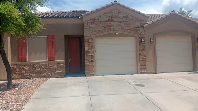 864 Chianti Way, Mesquite, NV 89027 - view of front of home with an attached garage, concrete driveway, a tiled roof, and stone siding