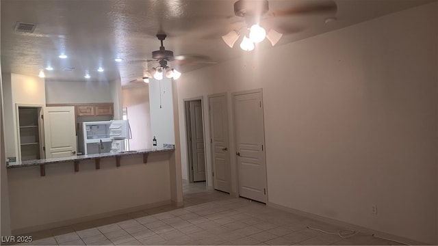 864 Chianti Way, Mesquite, NV 89027 - kitchen featuring a ceiling fan, light tile patterned floors, and baseboards