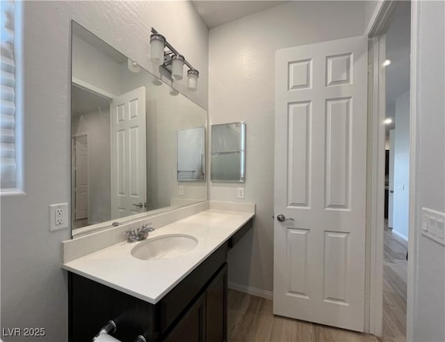 12565 Huckleberry Oak Ave, Las Vegas, NV 89138 - bathroom with vanity, wood finished floors, and baseboards