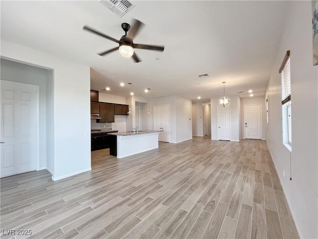 12565 Huckleberry Oak Ave, Las Vegas, NV 89138 - unfurnished living room featuring light wood finished floors, a ceiling fan, recessed lighting, baseboards, and a sink