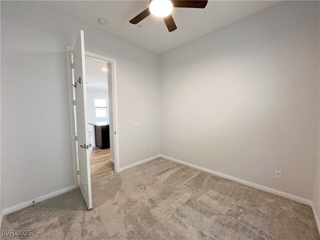 12565 Huckleberry Oak Ave, Las Vegas, NV 89138 - spare room featuring a ceiling fan, light colored carpet, baseboards, and a smoke detector