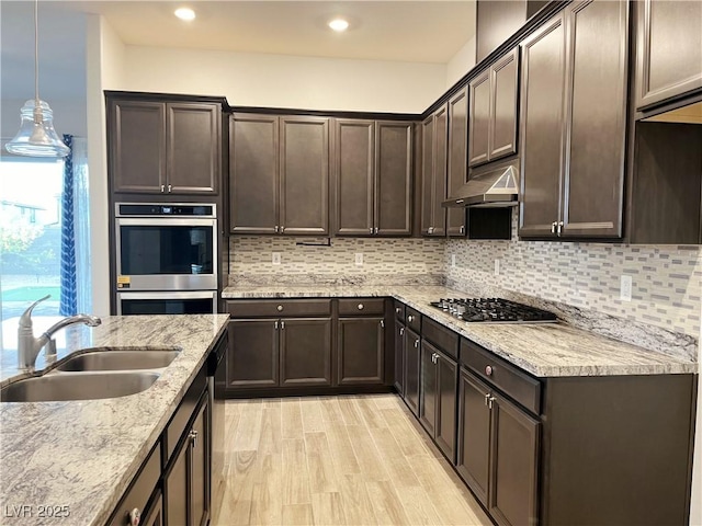 12565 Huckleberry Oak Ave, Las Vegas, NV 89138 - kitchen with stainless steel appliances, a sink, dark brown cabinetry, tasteful backsplash, and light stone countertops