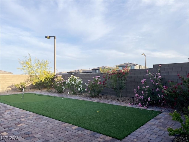 12565 Huckleberry Oak Ave, Las Vegas, NV 89138 - fenced backyard with a putting area