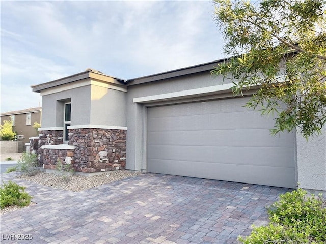 12565 Huckleberry Oak Ave, Las Vegas, NV 89138 - view of front facade with stone siding, stucco siding, decorative driveway, and an attached garage